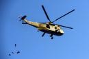 An army helicopter flies over Cairo's Tahrir Square during a rally on January 25, 2014