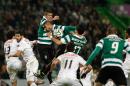 Sporting's Rojo, from Argentina, top, jumps for the ball during their Portuguese league soccer match with Academica, Sunday, Feb. 2 2014, at Sporting's Alvalade stadium in Lisbon. The game ended in a 0-0 draw. (AP Photo/Armando Franca)