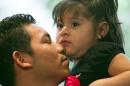 Luis Lopez, 24, hugs his daughter, Kimberly Canales, 2, at University Presbyterian Church in Tempe, Ariz., on Thursday, Sept. 4, 2014. Lopez who is a Guatemalan native and has been living in Phoenix and Mesa since 2007 and is currently in deportation proceedings is receiving Sanctuary from University Presbyterian Church. Kimberly is a U.S. citizen and Luis' wife is a legal resident. (AP Photo/The Arizona Republic, David Wallace)