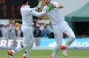 England's Stuart Broad, right, celebrates with Jos Buttler, left, after bowling Australia's Steve Smith caught Ian Bell for 33 runs during day four of the first Ashes Test cricket match, in Cardiff, Wales, Saturday, July 11, 2015. (AP Photo/Rui Vieira)