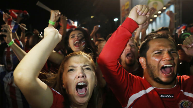 Costa Rica soccer fans celebrate their team&#39;s victory at the World Cup round of 16 match against Greece on a live telecast inside the FIFA Fan Fest area on Copacabana beach in Rio de Janeiro, Brazil, Sunday, June 29, 2014. Costa Rica won the penalty shootout 5-3 after the match ended 1-1. (AP Photo/Leo Correa)