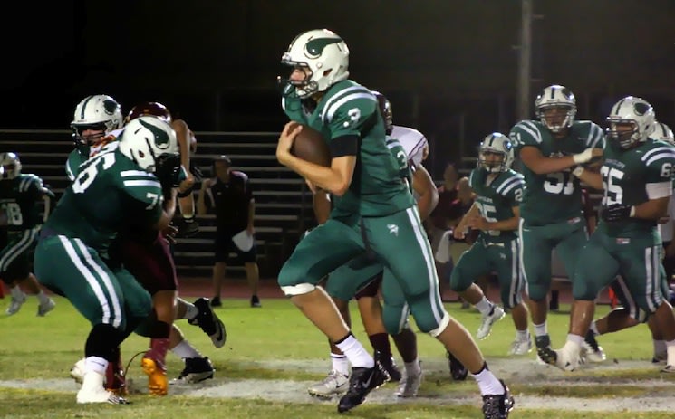 6-foot-10 QB and star basketball recruit Michael Humphrey scrambles during a recent game — Sunnyslope Football