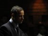 Oscar Pistorius stands in the dock ahead of court proceedings at the Pretoria magistrates court
