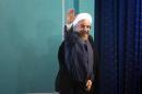 Iranian President Hassan Rouhani waves as he leaves a press conference in Tehran on August 30, 2014