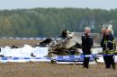 Belgian firefighters inspect pieces of debris at a site where a plane carrying 10 parachutists crashed shortly after takeoff near the village of Marchovelette, 10 kilometres (six miles) from the southern city of Namur on October 19, 2013