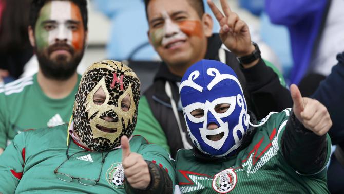 Mexico fans wear wrestler masks as they await their team&#39;s first round Copa America 2015 soccer match against Ecuador at Estadio El Teniente in Rancagua