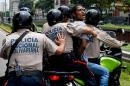 A man is arrested during a protest against new emergency powers decreed this week by President Nicolas Maduro, in Caracas on May 18, 2016
