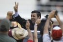 Iran's President Mahmoud Ahmadinejad makes a victory sign after attending the funeral ceremony for Venezuela's late President Hugo Chavez at the military academy in Caracas, Venezuela, Friday, March 8, 2013. Chavez died on March 5 after a nearly two-year bout with cancer. He was 58. (AP Photo/Fernando Llano)