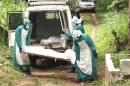 Health workers carry the body of an Ebola virus victim in Kenema
