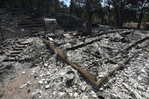 A burned out residence is seen as the Rocky fire burns &hellip;