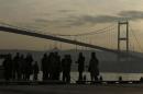 In this photo taken on Wednesday, Jan. 4, 2017, people stand by the Bosporus Strait in Istanbul. These days, with a string of terror attacks targeting Istanbul still fresh in his memory, some residents say they are adapting their daily routines because of fears they could become the latest victims of violent extremism. (AP Photo/Emrah Gurel)