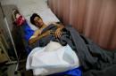 A man who was injured from clashes receives treatment in a hospital bed in the northern Iraqi city of Erbil