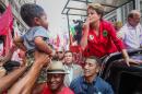Brazilian president and presidential candidate for the Workers Party, Dilma Rousseff (R) greets a child in Porto Alegre, Brazil, on October 25, 2014