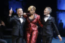 US singer Mary J. Blige, center, performs as Canadian fashion designers Dean Caten, left and Dan Caten acknowledge the applause of the audience after presenting their DSquared2 men's Fall-Winter 2015-2016 collection, part of the Milan Fashion Week, unveiled in Milan, Italy, Friday, Jan. 16, 2015. (AP Photo/Luca Bruno)