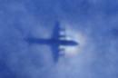 In this Monday, March 31, 2014 photo, a shadow of a Royal New Zealand Air Force P-3 Orion aircraft is seen on low cloud cover while it searches for missing Malaysia Airlines Flight MH370 in the southern Indian Ocean. Malaysia's national police chief has warned that the investigation into what happened to the plane may take a long time and may never determine the cause of the tragedy. Khalid Abu Bakar said Wednesday, April 2, that the criminal investigation is still focused on four areas — hijacking, sabotage and personal or psychologica problems of those on board the plane. (AP Photo/Rob Griffith, Pool)