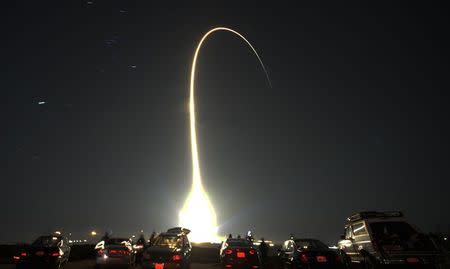 File photo of people watching as a United Launch Alliance Atlas V rocket, carrying a classified payload from the U.S. government&#39;s National...