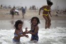 Celeste Hidalgo, 7, and Alana Griego, 5, cool off in the Pacific ocean during a heat wave in Santa Monica