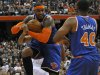 New York Knicks' Carmelo Anthony, center, grabs a rebound against the Philadelphia 76ers during the first quarter of an NBA preseason basketball game, Monday, Oct. 22, 2012, in Syracuse, N.Y. (AP Photo/Kevin Rivoli)