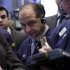 In this Friday, Jan. 25, 2013, photo, Trader Michael Urkonis, center, works on the floor of the New York Stock Exchange. Wall Street appeared headed for a day of trade without drama Monday Jan. 28, 2013.  (AP Photo/Richard Drew)