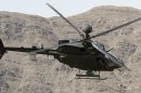 A U.S. military Kiowa attack helicopter flies over a part of Sangum Ghaki Valley to provide security for U.S.-Afghan Army soldiers joint patrol in Kunar province