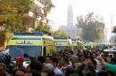 Egyptian Christians shout slogans as ambulances transport the bodies of victims killed in the bombing of Cairo's main Coptic cathedral after the funeral, in Cairo, Egypt
