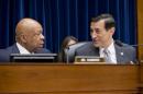 FILE - In this Dec. 4, 2013, file photo, House Oversight and Government Reform Committee Chairman Rep. Darrell Issa, R-Calif., right, confers with the committee's ranking Democrat, Rep. Elijah Cummings, D-Md., on Capitol Hill in Washington, before the start of the committee's hearing on the implementation of the Affordable Care Act's HealthCare.gov website. The top cybersecurity officer for the federal Health and Human Services department was concerned about potential vulnerabilities ahead of the launch of the Obama administration's health care website. Issa, investigating the chaotic rollout of the website contends the administration risked the personal information of millions of Americans in its zeal to meet a self-imposed Oct. 1 deadline. Cummings says the administration addressed the potential security issues through added vigilance instituted before the site went live. (AP Photo/J. Scott Applewhite, File)
