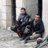 Free Syrian Army fighters carry their weapons at the Sheikh Saeed district in Aleppo