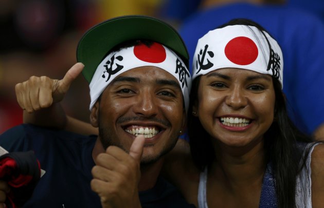 Fans of Japan smile before the team&#39;s Confederations Cup Group A soccer match against Italy at the Arena Pernambuco in Recife