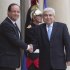 France's President Francois Hollande, left, and Cypriot President Demetris Christofias, right, shake hands for the media at the Elysee Palace in Paris, Friday, Oct. 26, 2012. (AP Photo/Michel Euler)