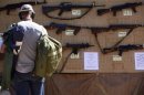 A man look at different rental guns displayed during the Big Sandy Shoot in Mohave County