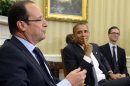 U.S. President Barack Obama listens to French President Francois Hollande speak as they meet at the White House in Washington