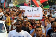 Demonstrators are seen holding a sign 'People don't want militias' during a protest march in Benghazi, on September 21. Thousands of Libyans rallied against militias in the tense city, drowning out a protest by radical Salafists furious over a film and cartoons deemed offensive to Islam