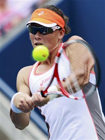 Stosur of Australia hits a return to Martic of Croatia during their women's singles match at the U.S. Open tennis tournament in New York