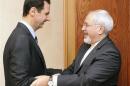 Syria's President Bashar al-Assad welcomes Iran's Foreign Minister Mohammad Javad Zarif, before a meeting in Damascus