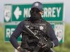 A federal policeman guards the area where dozens of bodies, some of them mutilated, were found on a highway connecting the northern Mexican metropolis of Monterrey to the U.S. border found in the town of San Juan near the city of Monterrey, Mexico,  Sunday, May 13, 2012. (AP Photo/Christian Palma)