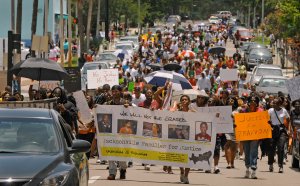 Protesters make their way down East Duval Street on …
