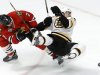 Boston Bruins left wing Daniel Paille, right, shoots as he collides with Chicago Blackhawks defenseman Brent Seabrook during the third period of Game 1 in their NHL Stanley Cup Final hockey series on Wednesday, June 12, 2013, in Chicago. (AP Photo/Charles Rex Arbogast)