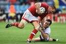 Canada's centre Nick Blevins (L) is tackled during the Pool D match of the 2015 Rugby World Cup between Canada and Romania at Leicester City Stadium in Leicester, central England, on October 6, 2015