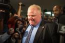 Toronto Mayor Rob Ford is surrounded by media as he leaves his office at Toronto City Hall on this November 15, 2013