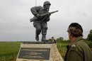 In this picture taken on Tuesday, June 5, 2012, shows the Colorado-made statue of Pennsylvania native Maj. Dick Winters, unveiled on Wednesday, June 6, 2012 near the beaches where the D-Day invasion of France began in 1944, one of many events marking the 68th anniversary of D-Day, the Allied operation that paved the way for the end of the war. The bronze statue built near the village of Sainte Marie du Mont, is a tribute to a man whose quiet leadership was chronicled in the book and television series "Band of Brothers." (AP Photo/Remy de la Mauviniere)