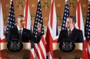 Britain's Prime Minister David Cameron and US President Barack Obama attend a press conference at the Foreign and Commonwealth Office in central London