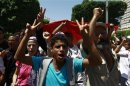 Protesters shout slogans while marching on the streets in Tunis