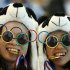 Two Chinese fans pause for photos prior to the Women's Synchronized 10 Meter Platform Diving final at the Aquatics Centre in the Olympic Park during the 2012 Summer Olympics, London, Tuesday, July 31, 2012. (AP Photo/Jae C. Hong)