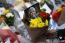Flowers and tributes are left for South Africa's former president Nelson Mandela at South Africa's High Commission in London