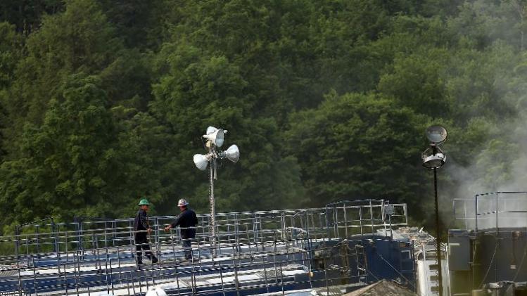 Men work on a natural gas valve at a hydraulic fracturing site on June 19, 2012 in South Montrose, Pennsylvania