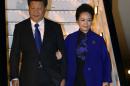 Chinese President Xi Jinping (L) and his wife Peng Liyuan, arrive at Heathrow Airport in west London on October 19, 2015, for a four-day state visit