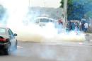 Police fire tear gas at polytechnic students protesting the closure of schools in Abuja on April 29, 2014