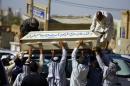 Mourners carry the coffin of a man killed after a bomb targeted the neighbourhood of Shaab, during his funeral in the central city of Najaf on May 13, 2014