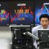A currency trader watches monitors in front of screens showing the Korea Composite Stock Price Index (KOSPI), center, and foreign exchange rate, left, at the foreign exchange dealing room of the Korea Exchange Bank headquarters in Seoul, South Korea, Thursday, Nov. 8, 2012. South Korea's Kospi dropped 1.19 percent at 1,914.43. (AP Photo/Ahn Young-joon)
