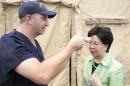 Margaret Chan, head of the World Health Organization, has her temperature measured during a visit to an Ebola medical unit on December 19, 2014, in the Liberian capital Monrovia